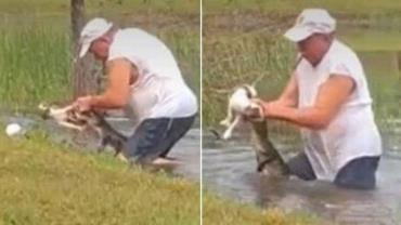 Homem tira cachorro da boca de jacaré em lago